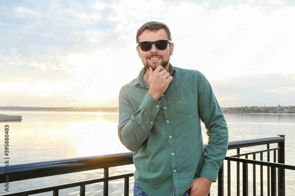 Handsome man with stylish sunglasses outdoors