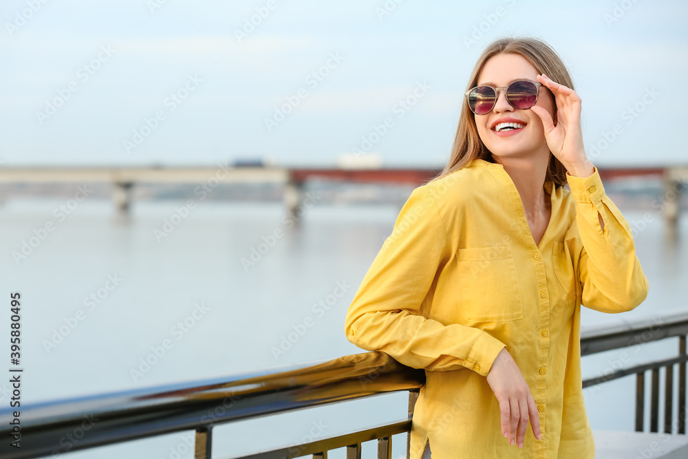 Beautiful woman with stylish sunglasses outdoors