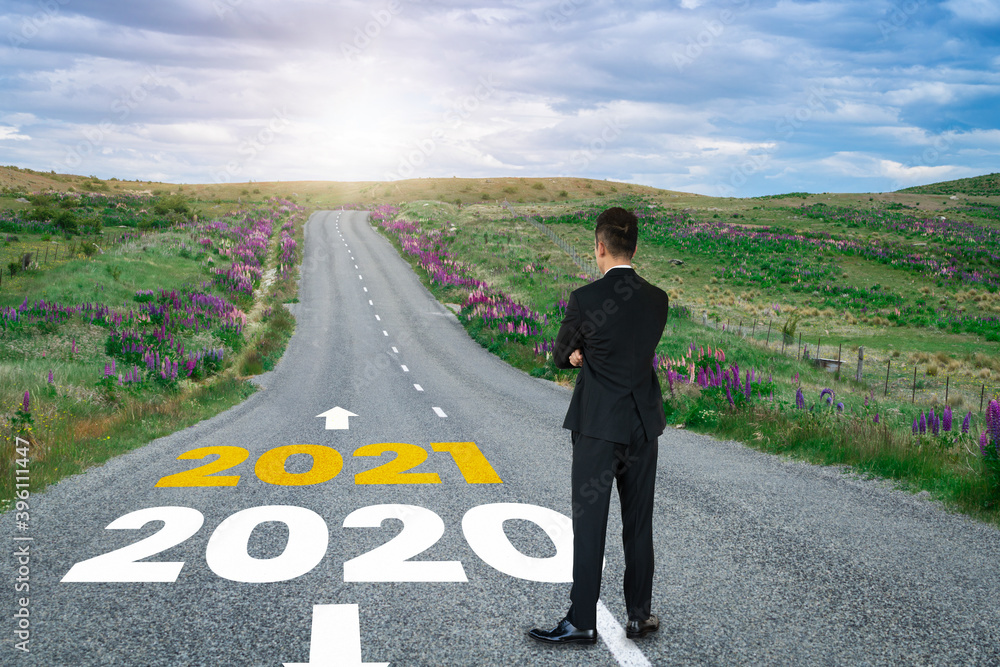 The 2021 New Year journey and future vision concept . Businessman traveling on highway road leading 