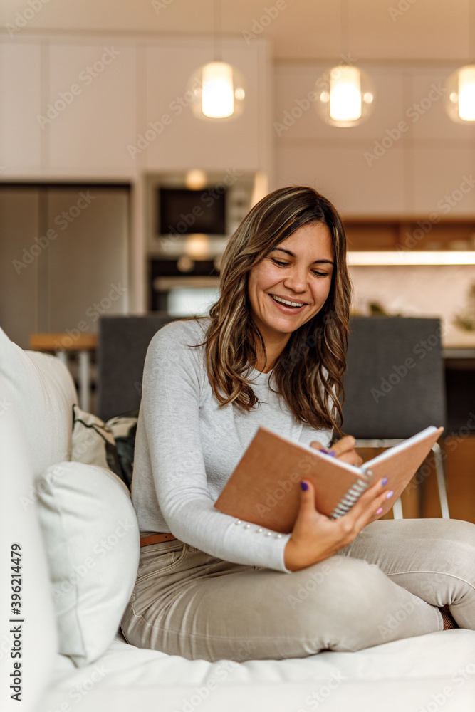 Relaxing at home, sitting on the sofa.