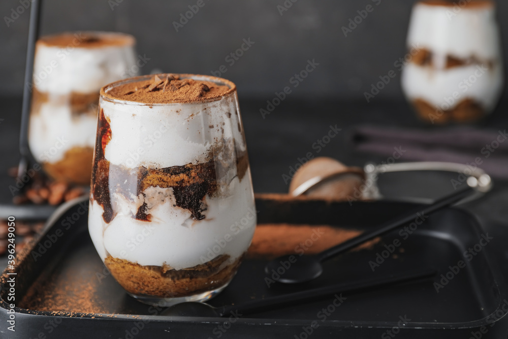 Sweet tasty tiramisu on table