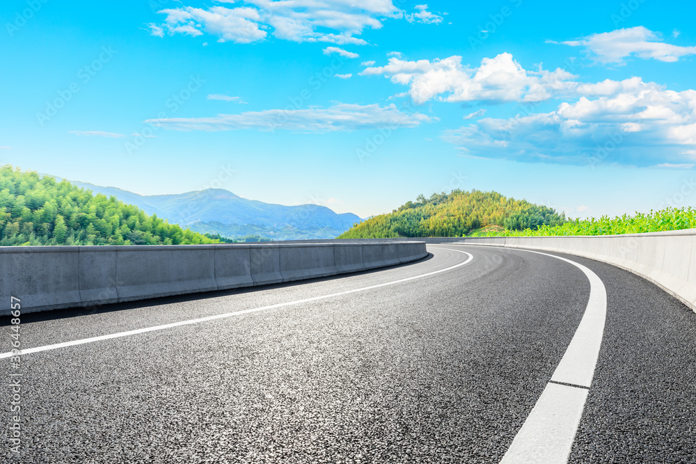 Asphalt road and green mountain with bamboo forest natural landscape.