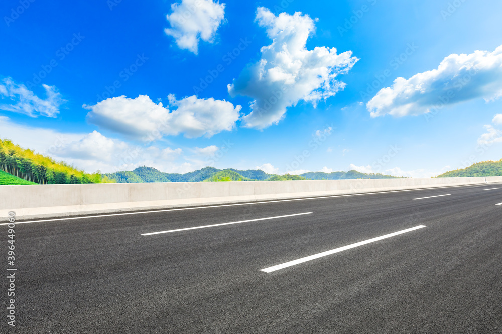 Asphalt road and green mountain with bamboo forest natural landscape.