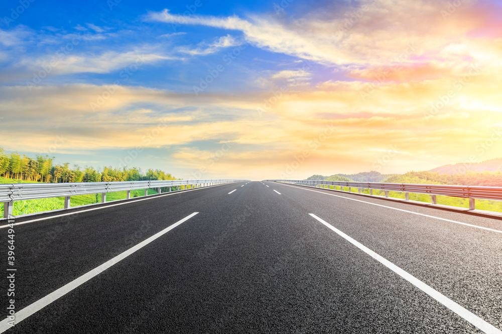 Country asphalt road and green tea plantation with bamboo forest natural landscape.