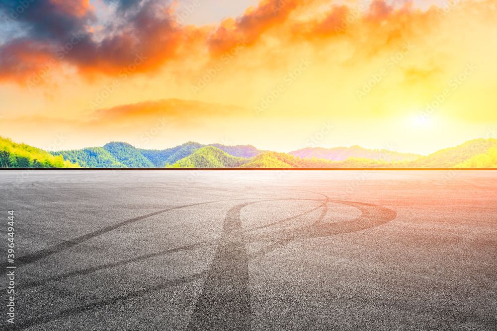 Asphalt road and green mountain with bamboo forest natural landscape at sunset.