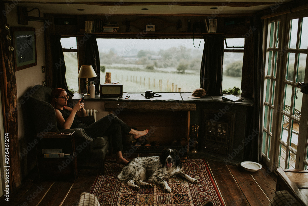 Woman sitting on a couch using smartphone