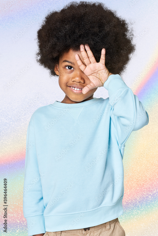 Black boy wearing blue sweater in studio