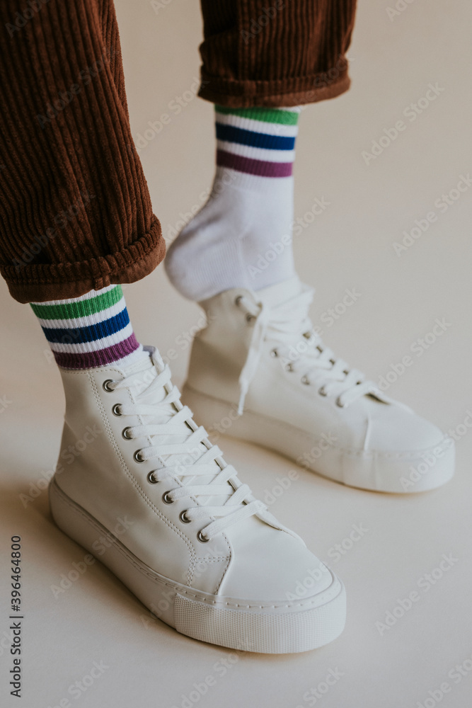 Man putting on white high top sneaker