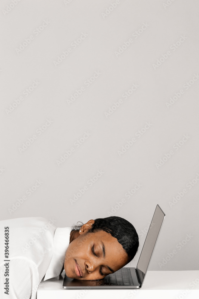 Exhausted black woman asleep on a laptop