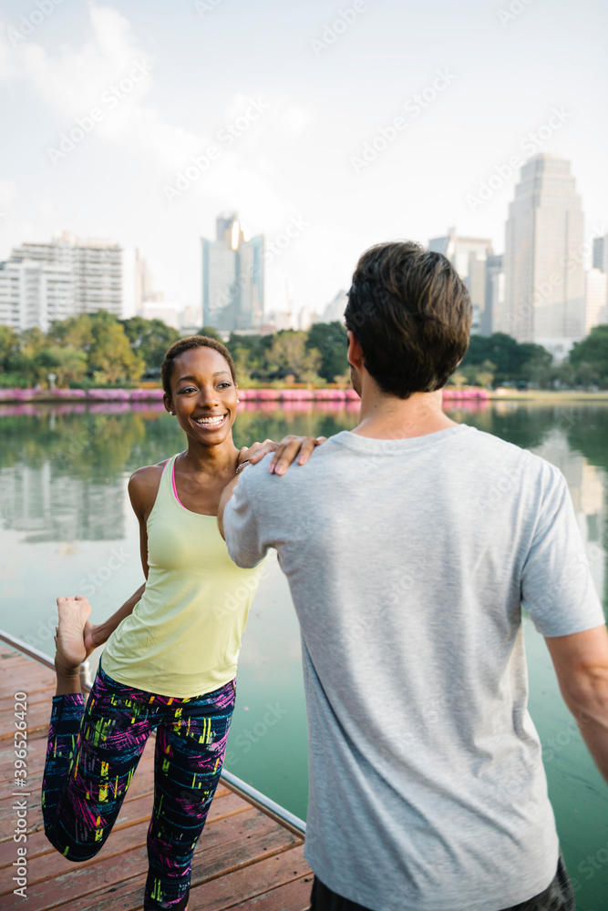 Couple doing a yoga in a park