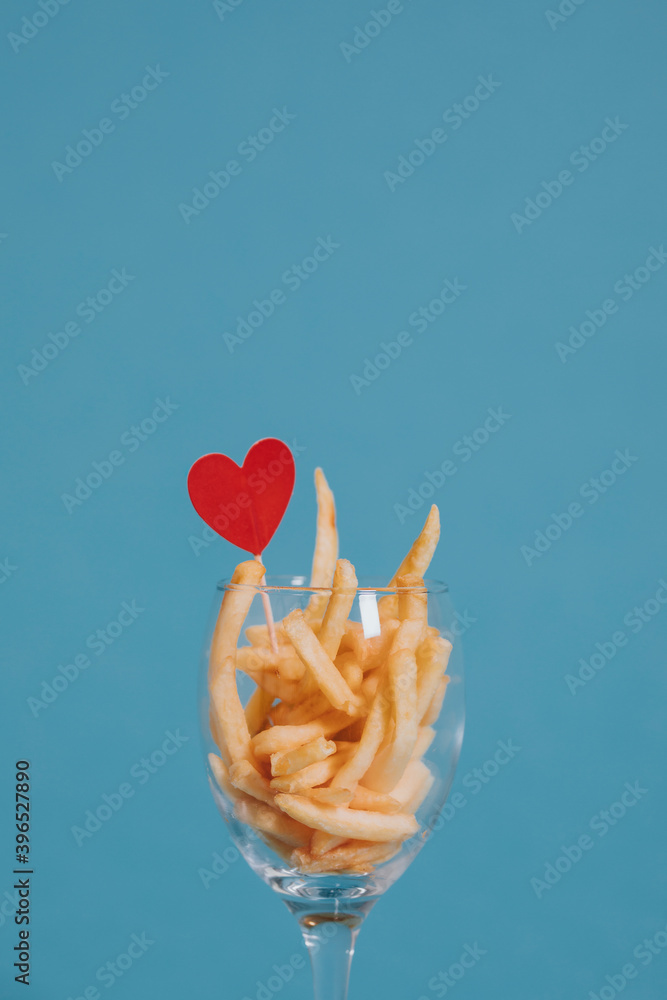 French fries in a wine glass with a heart ornament