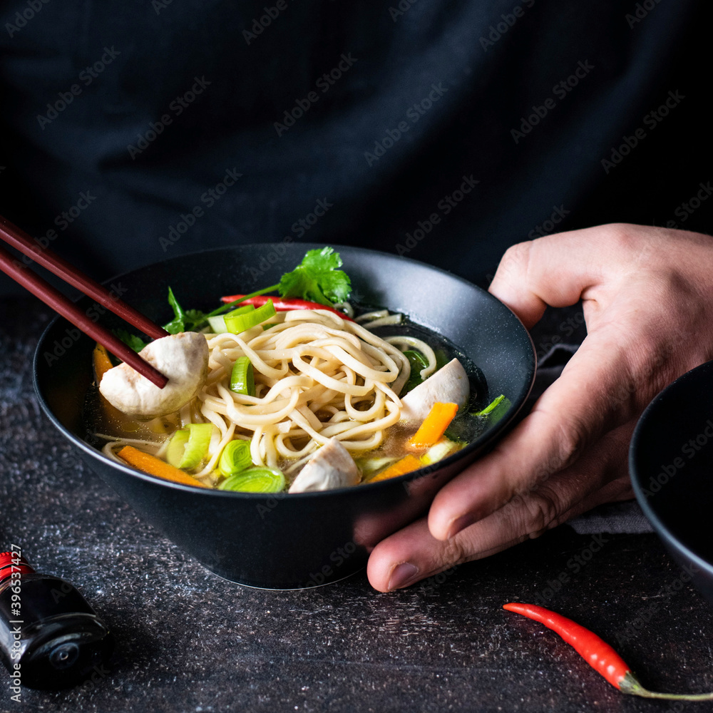 Authentic Asian noodle soup in a black bowl