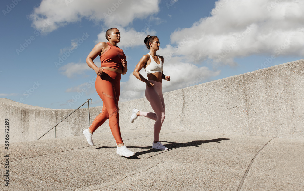 Two women jogging together