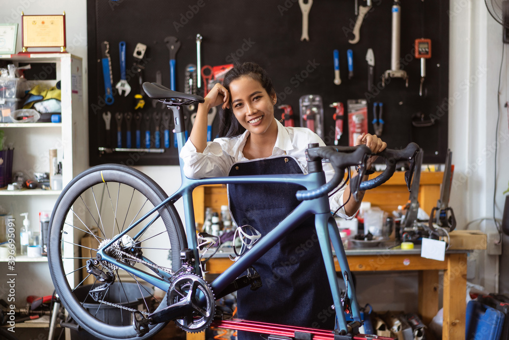 Repair technician woman bicycles was repaired gear bike shop.