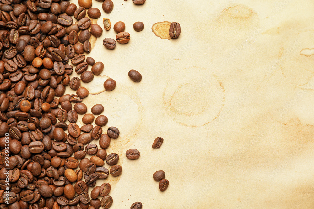 Brown coffee stains and beans  on light background