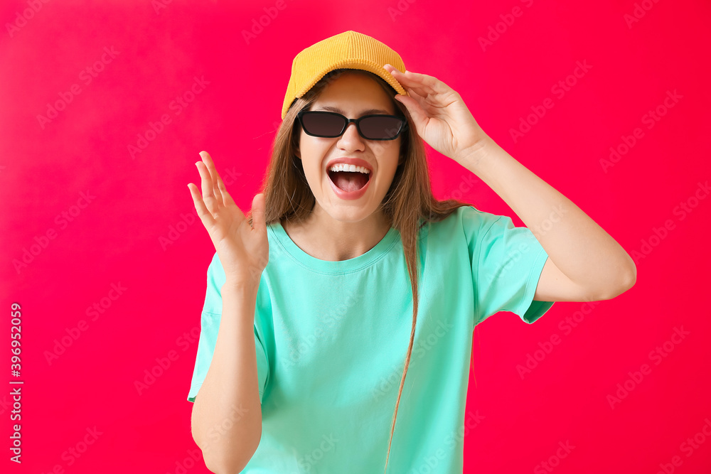 Happy woman with stylish sunglasses on color background