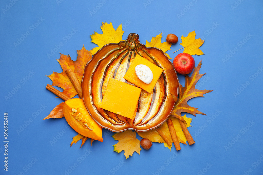 Plate with pieces of tasty pumpkin pie on color background