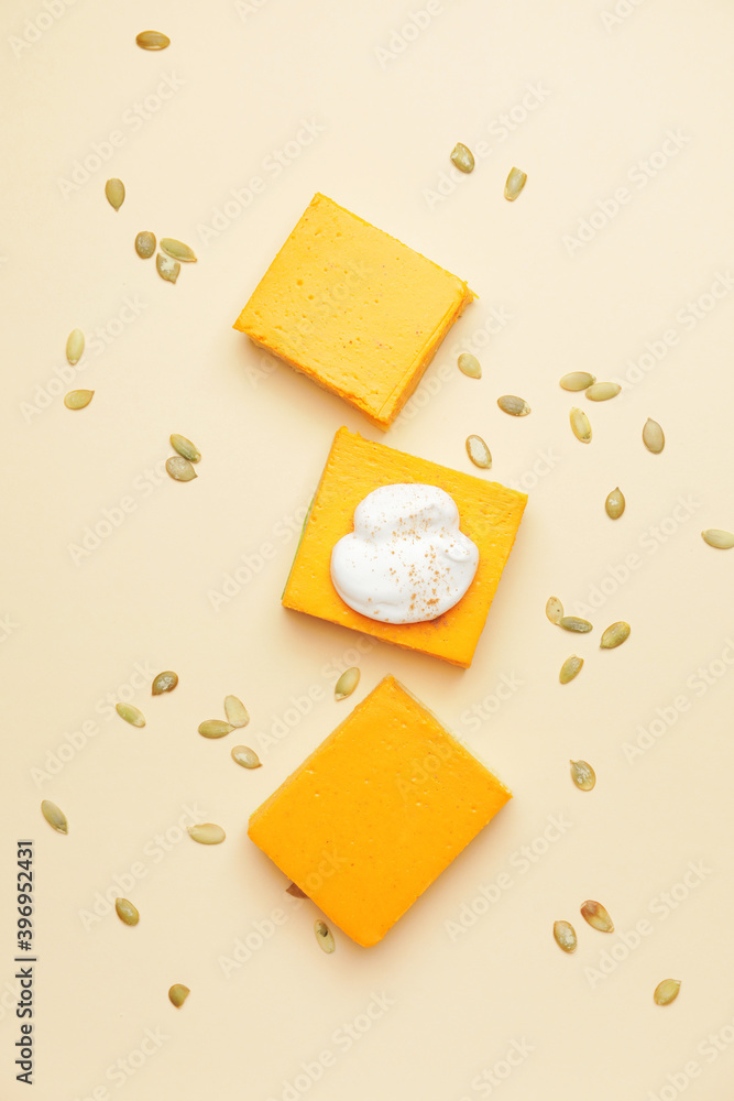 Pieces of tasty pumpkin pie on color background