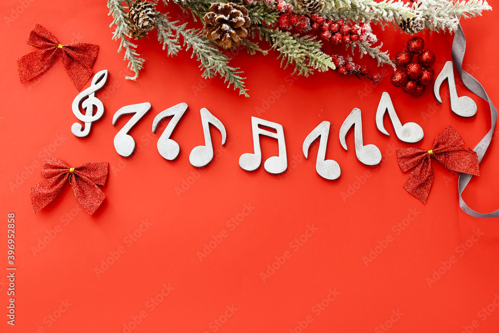 Note signs and Christmas decor on color background