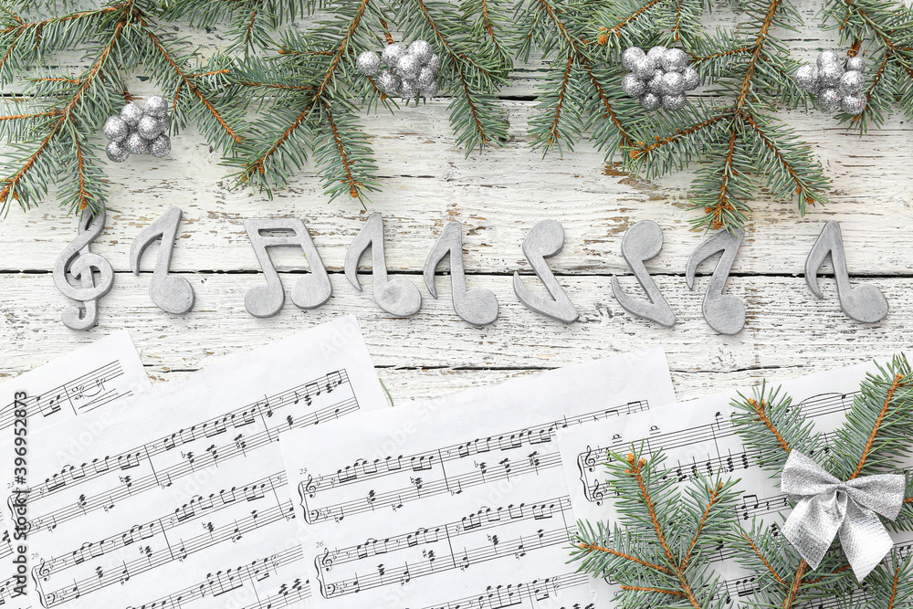 Note sheets and Christmas decor on wooden background