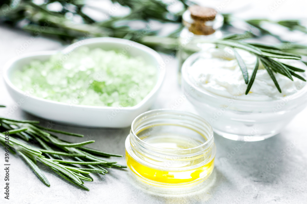 natural essential aroma oil with rosemary on stone table background