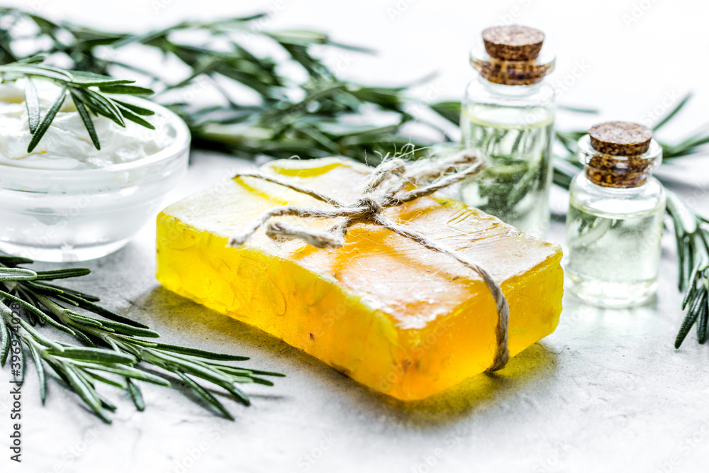 natural essential aroma oil with rosemary on stone table background