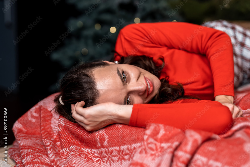 Charming woman laying on bed smiling and posing. Lady looking at camera. New year photosession.