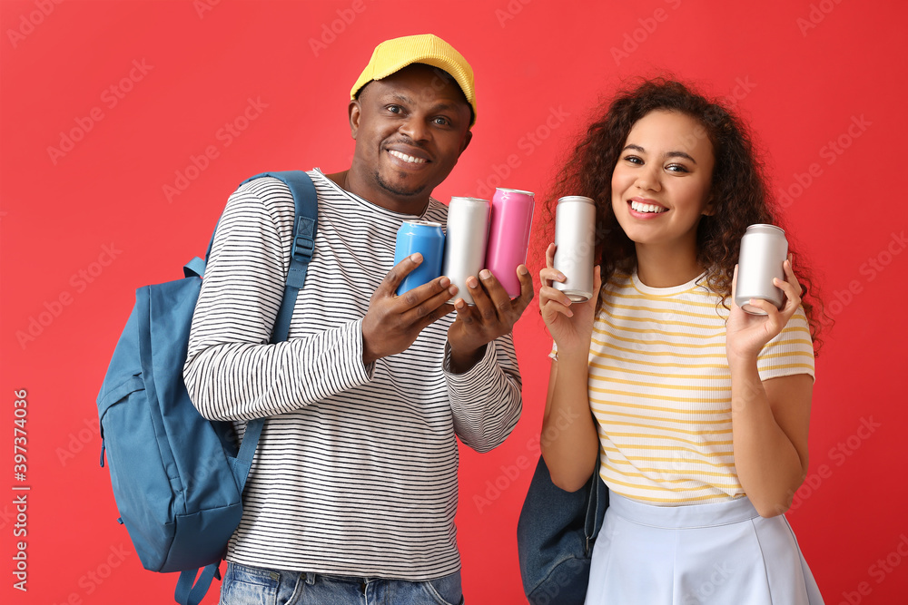 African-American couple with soda on color background