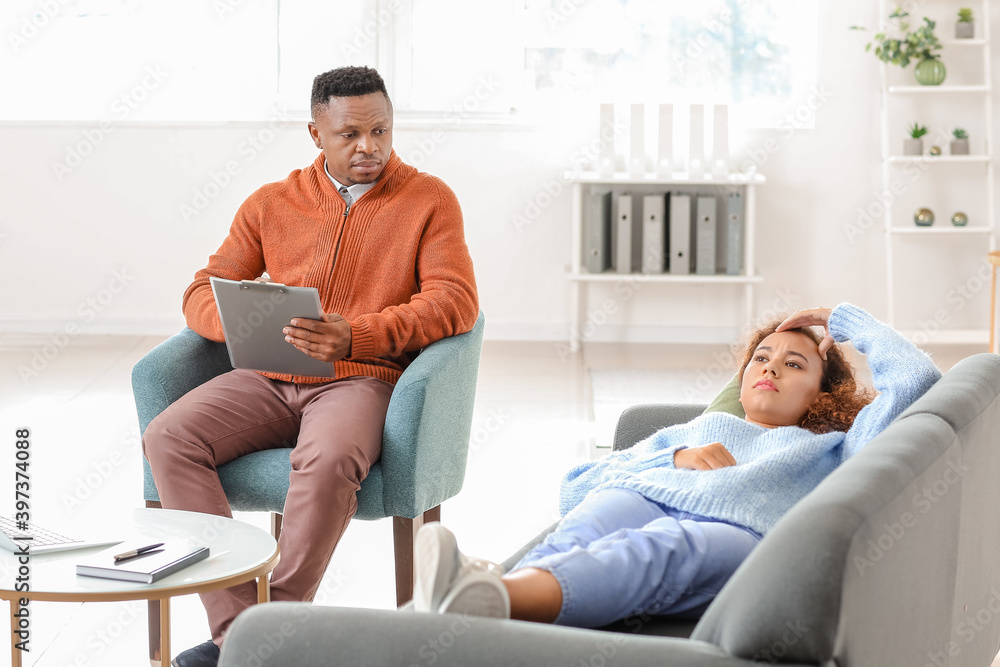 Psychologist working with African-American woman in office