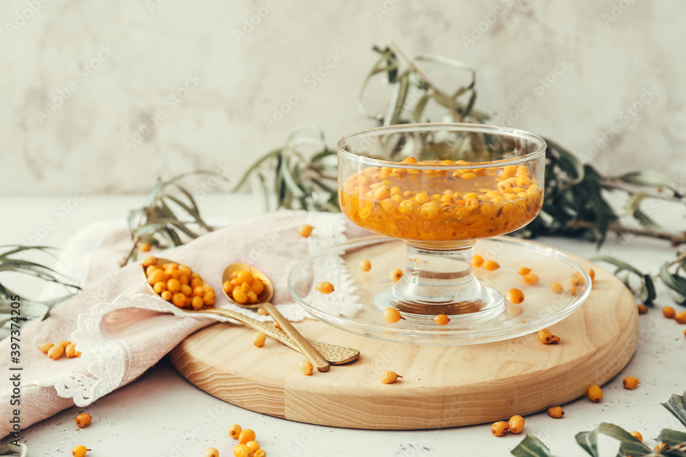 Tasty homemade sea buckthorn jam on table