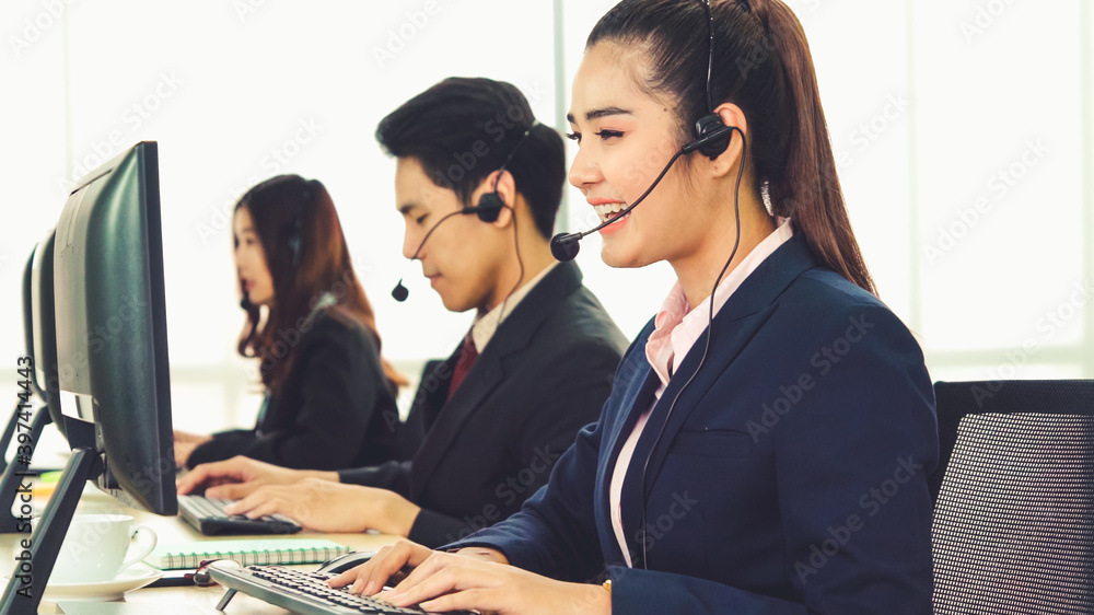 Business people wearing headset working in office to support remote customer or colleague. Call cent