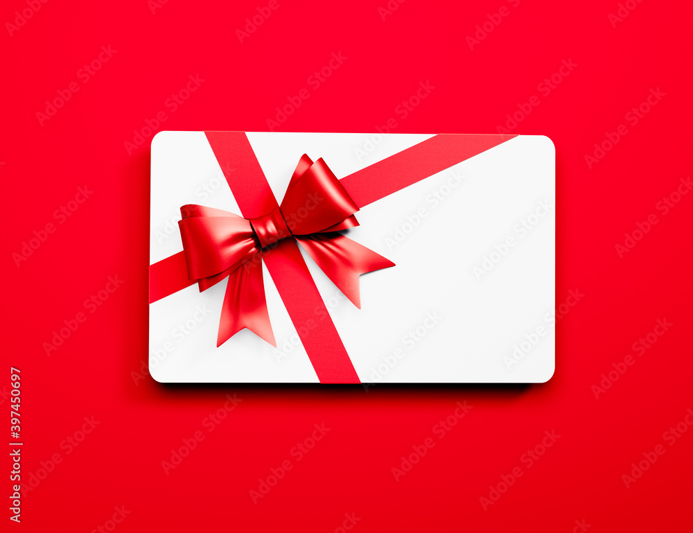 White credit or gift card with red ribbon isolated on red background - 3D illustration	