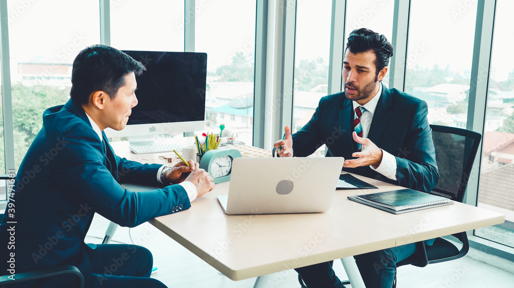 Two business people talk project strategy at office meeting room. Businessman discuss project planni