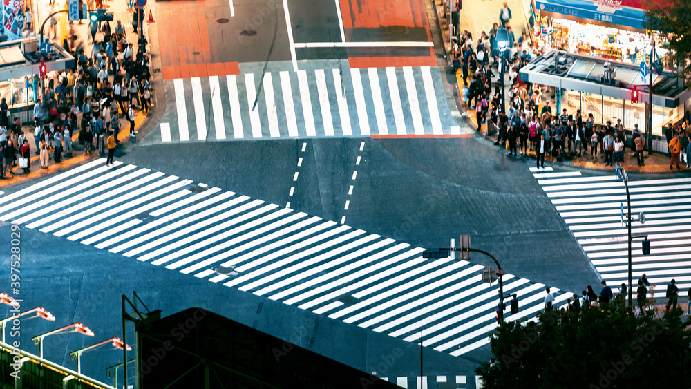 People and traffic cross the famous scramble intersection in Shibuya, Tokyo, Japan, one of the busie