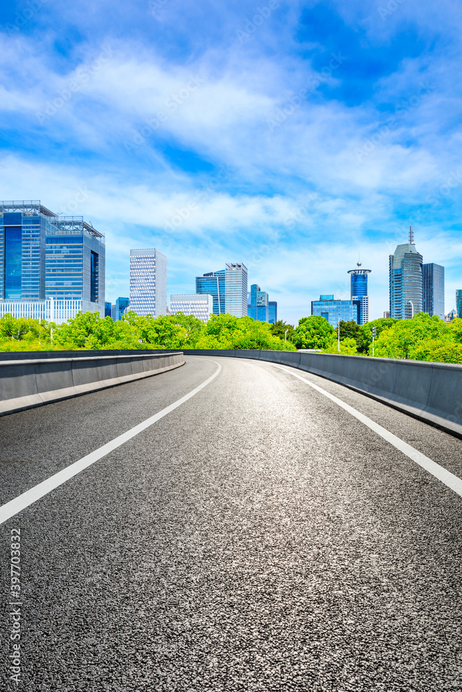 Empty asphalt road and Shanghai skyline with buildings scenery.