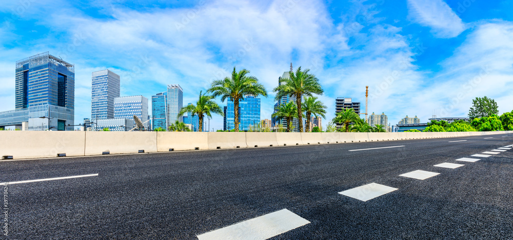 Empty asphalt road and Shanghai skyline with buildings scenery.