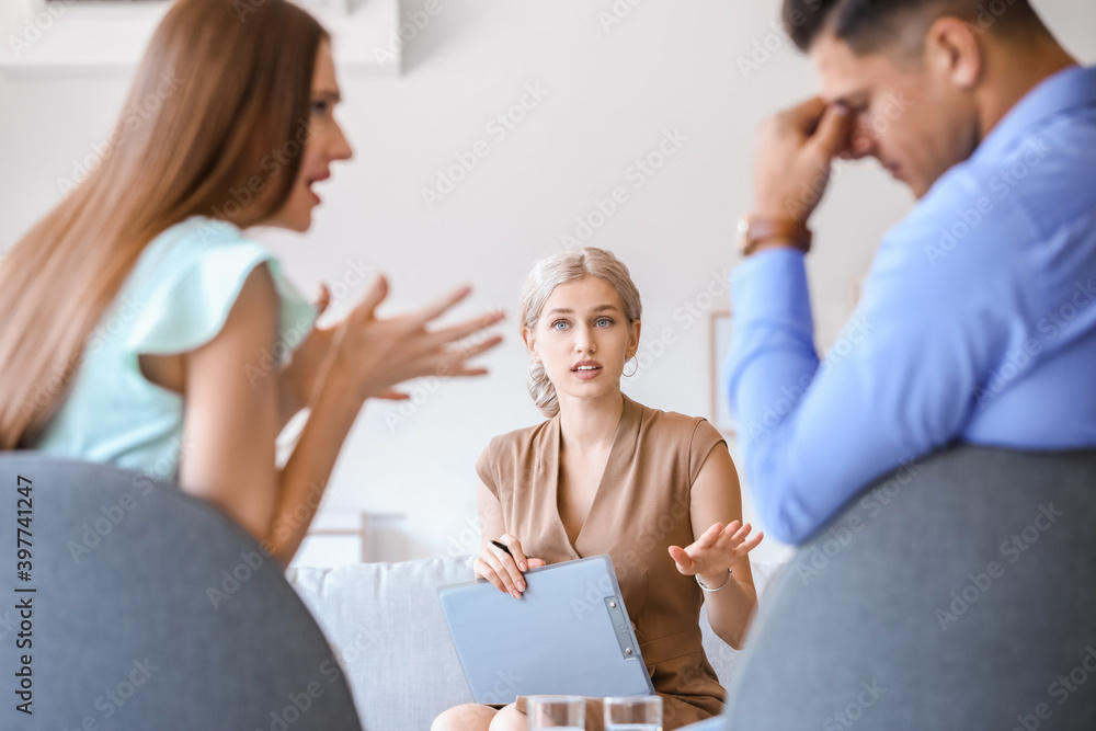 Psychologist working with young couple in office