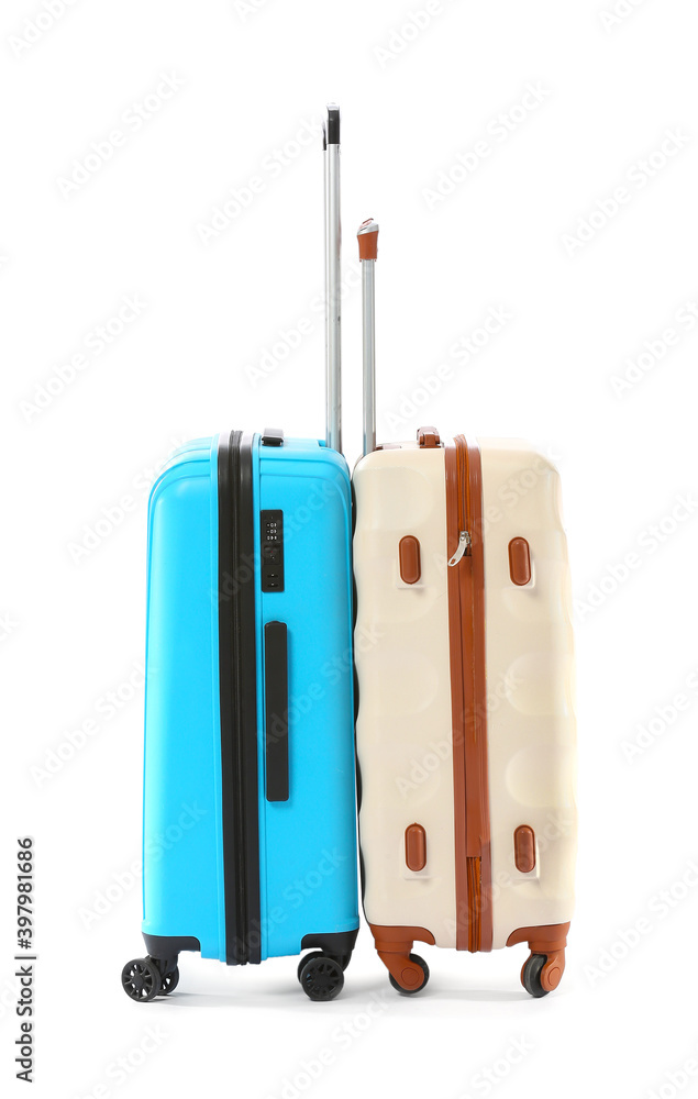 Packed suitcases on white background