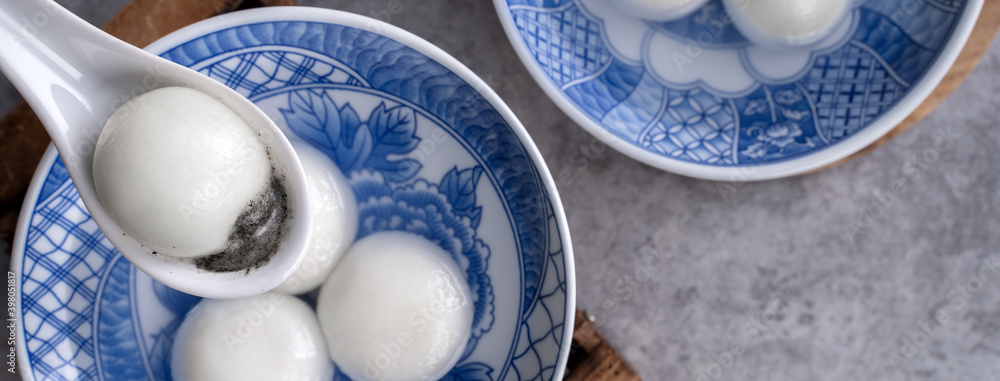 Top view of big tangyuan yuanxiao in a bowl on gray background for lunar new year food.