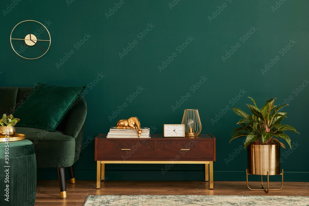 Luxury interior with stylish velvet sofa, wooden commode, pouf, plants, carpet, gold decoration, cop