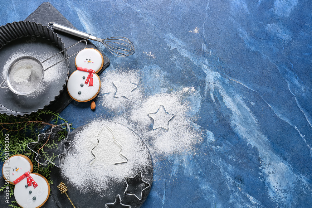 Flour for Christmas cookies and baking utensils on color background