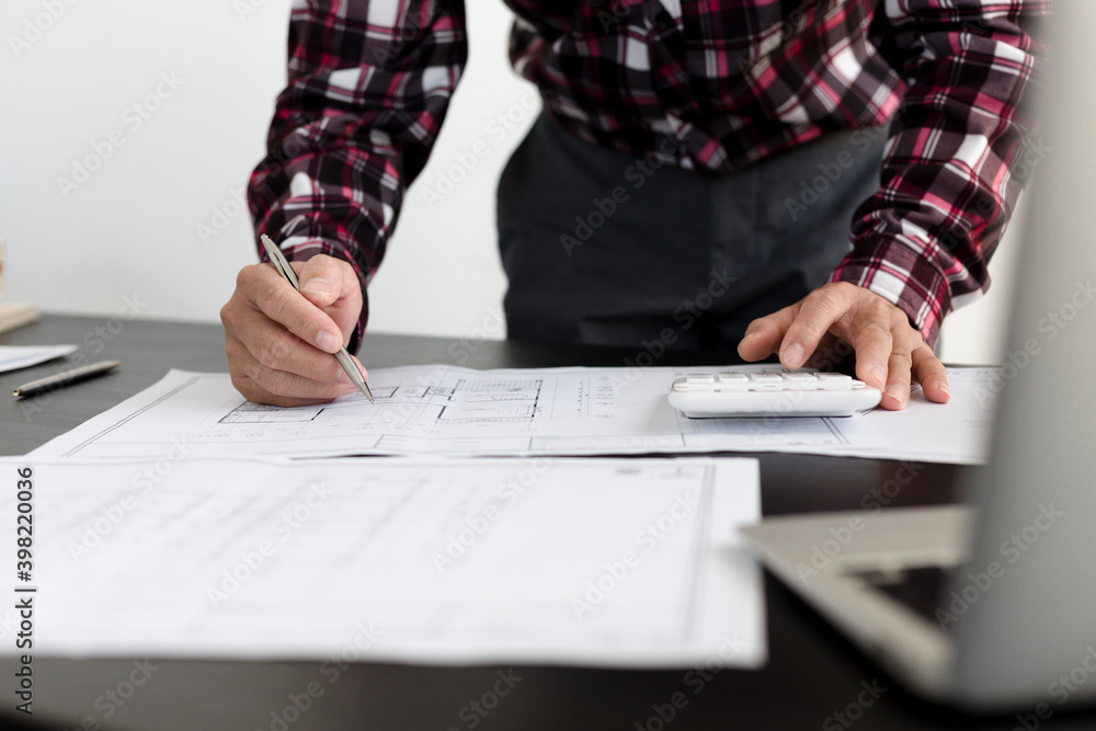 An engineer is examining the floor plan in the office building to calculate the construction budget 