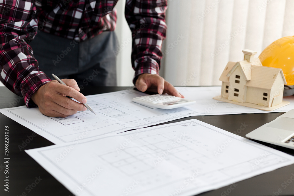 An engineer is examining the floor plan in the office building to calculate the construction budget 