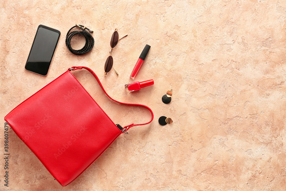 Stylish bag, accessories and mobile phone on color background