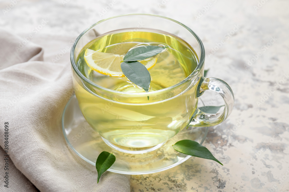 Cup of tasty green tea on table