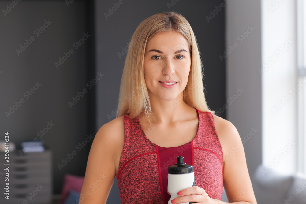 Sporty young woman training at home