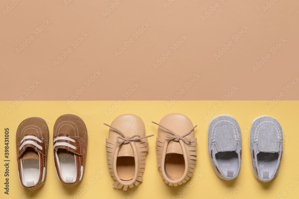 Baby shoes on color background