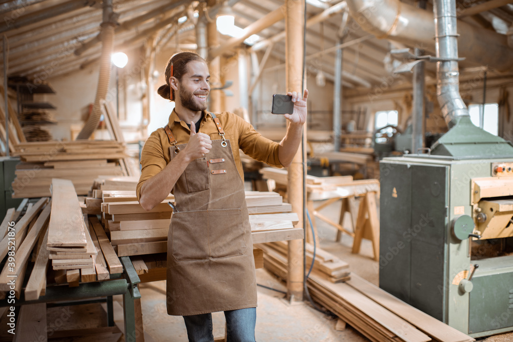 Carpenter using phone in the workshop