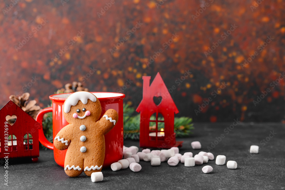 Christmas composition with gingerbread cookie and cup of cacao drink on dark background