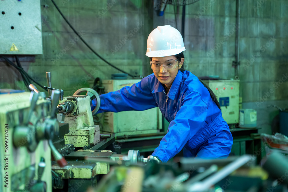 Engineering worker women in blue uniform working at factory,Engineering and industrial concept.